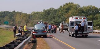 Car accident at side of road with emergency workers and ambulance; image by Ragesoss, via Wikimedia Commons, CC BY-SA 3.0, no changes.