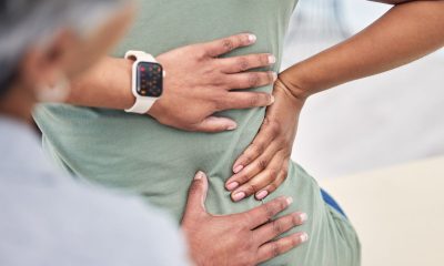 lower back pain hand on patient