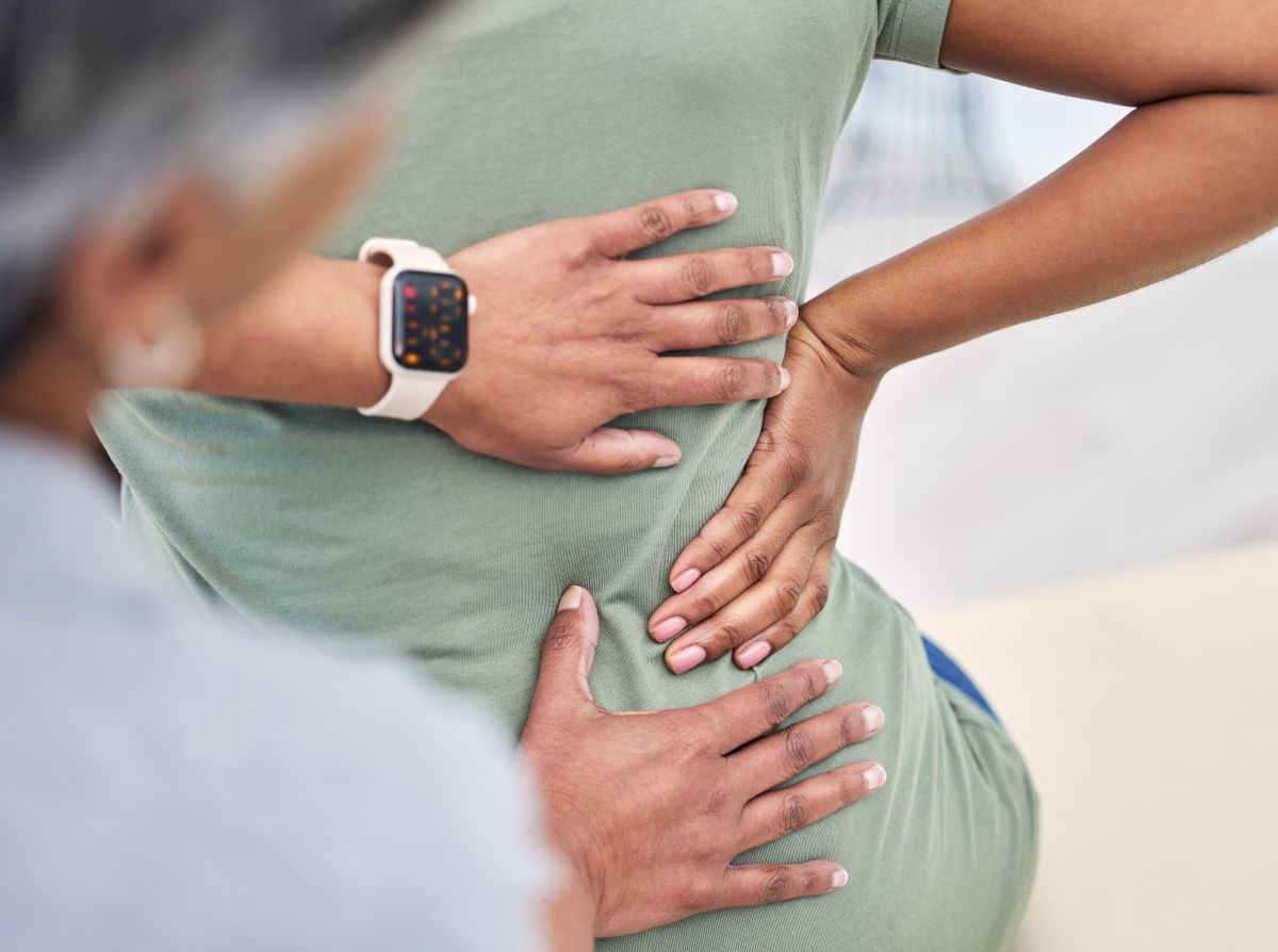 lower back pain hand on patient